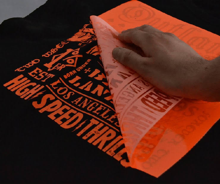 A heat image transfer being peeled off a garment.