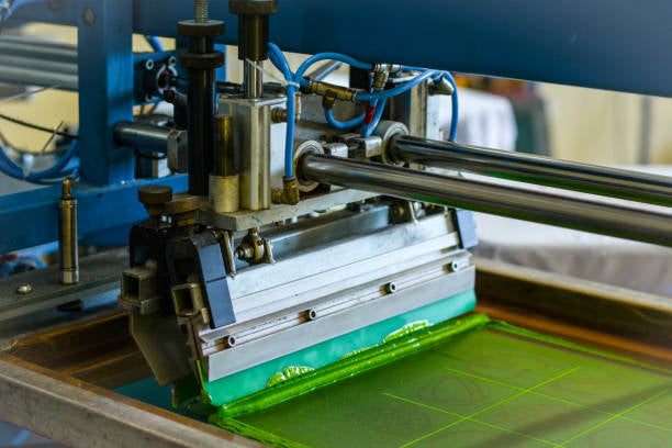 A screen print machine adding color to a garment. 