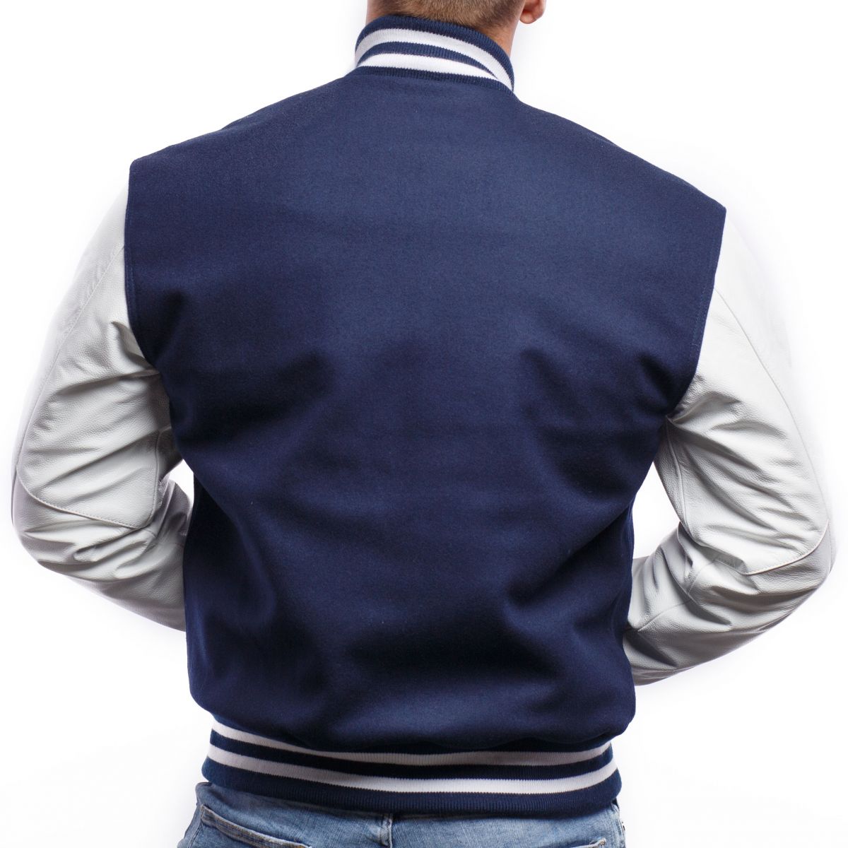 A person wearing a Royal Blue Wool Body & Bright White Leather Sleeves Letterman Jacket.